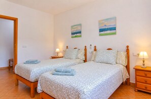 A double room with two beds, each with a matching nightstand and lamp. - Sa Vinya 405 fantastic rustic finca with private pool, terrace, garden and air conditioning (Campos)