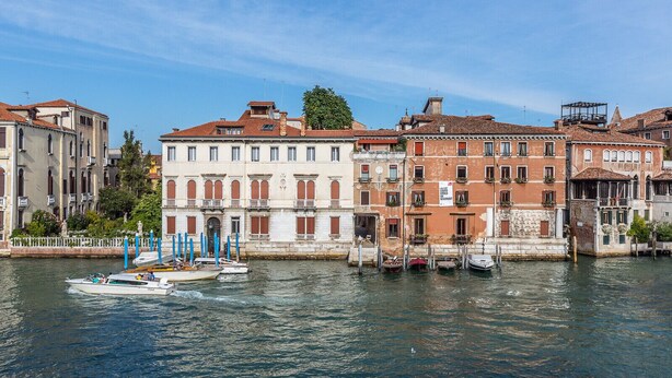 A canal with buildings along the water's edge. - Ca' Mainella Grand Canal (Venice)