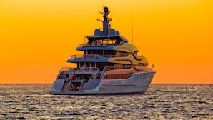 A large yacht with multiple decks and a helipad, sailing on the ocean during sunset. - Apartment in Ist with Seaview, Terrace, Air condition, WIFI (3752-1) (Ist)