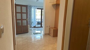 A hallway leading to a room with a sliding glass door, a small wooden cabinet, and a tiled floor. - Apartment in Lumbarda with Seaview, Terrace, Air condition, WIFI (128-1) (Lumbarda)