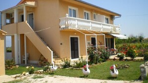 A two-story house with a balcony, a staircase, and a garden with swans. - Apartment in Privlaka with Seaview, Balcony, Air condition, WIFI (667-2) (Privlaka)