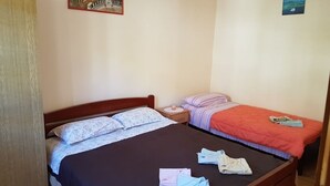 A bedroom with two beds, a nightstand, and a painting on the wall. - Apartment in Basina with Seaview, Terrace (3450-3) (Stari Grad)