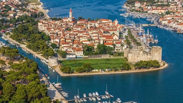 An aerial view of a coastal town with a prominent castle, marina, and surrounding residential buildings. - Apartment in Seget Vranjica with Seaview, Balcony, Air condition, WIFI (91-3) (Seget Vranjica)