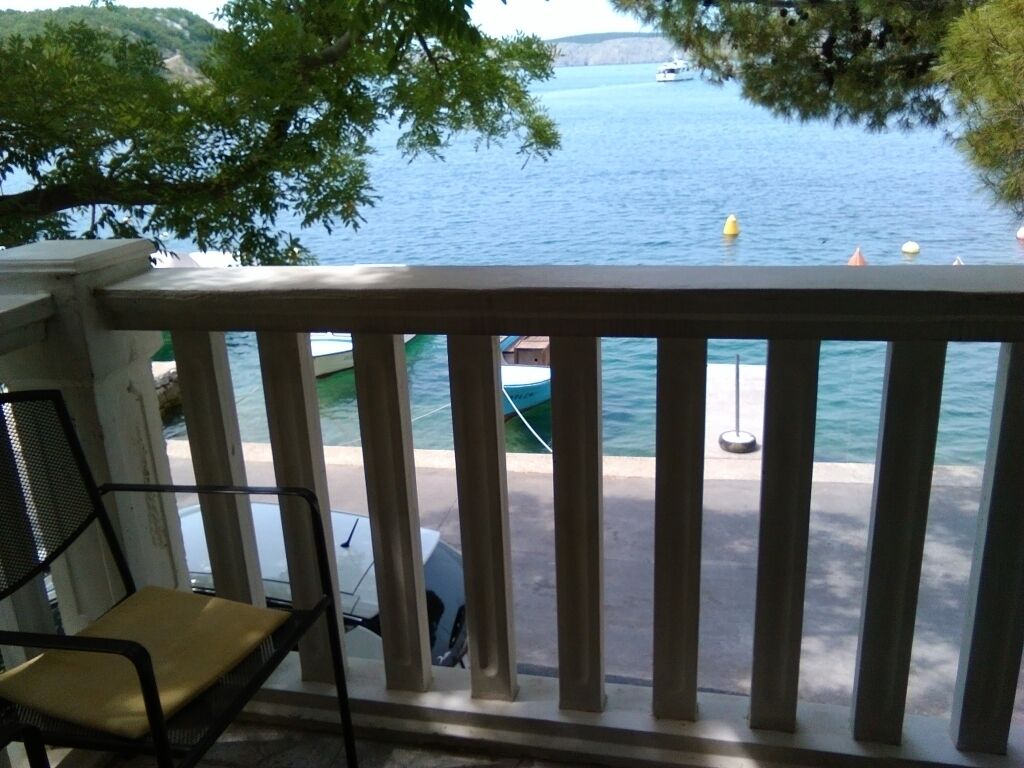 A balcony with a view of a lake and boats.