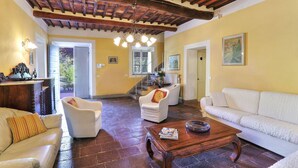 A spacious living room with a high wooden ceiling, a fireplace, and a staircase leading to another level. - Villa in San Concordio Di Moriano with 6 bedrooms sleeps 12 (Lucca)