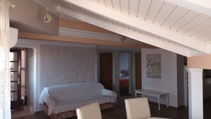 A bedroom with a bed, a chair, a table, and a clock on the wall. - Apartment in Privlaka with Terrace, Air condition, WIFI, Washing machine (821-3) (Privlaka)