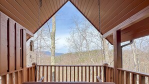 A wooden deck with a triangular ceiling and a view of trees and mountains. - Hot Tub, Pool Table & Mtn View! Pool, Putt Putt, Fishing, Golf, Hiking, etc. (Sevierville)
