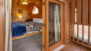 A cozy cabin room with a bed, a window, and a door leading outside. - Hot Tub, Pool Table & Mtn View! Pool, Putt Putt, Fishing, Golf, Hiking, etc. (Sevierville)