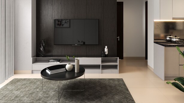 A modern living room with a flat-screen TV mounted on a dark wood panel wall, a black coffee table with books and a vase, and a kitchen area with a countertop and stove. - Saigon Royal Tower! (Ho Chi Minh)