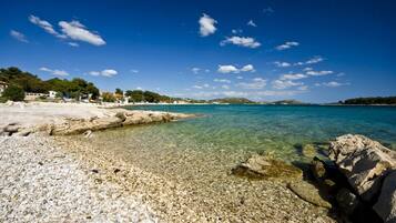 Enjoy a serene beach experience with access to the ocean and stunning views of the surrounding landscape.