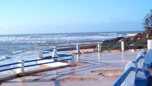 A coastal walkway with a railing, leading to the beach. - Nice apartment with pool access 4300 (Sidi Bouzid)