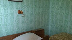 A neatly made bed with white bedding, a green towel, and a patterned pillow. - Apartment in Kampor with Balcony, WIFI, Washing machine (895-1) (Kampor)