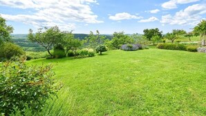 A lush green lawn with trees and shrubs, a clear sky, and distant hills. - Apartment in Roč with Terrace, Air condition, WIFI, Washing machine (4194-2) (Roc)