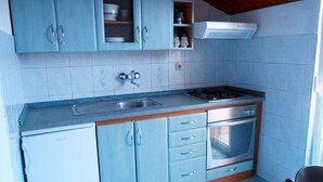 A compact kitchen with a refrigerator, stove, oven, and a sink. - Apartment in Poljana with Seaview, Balcony, Air condition, WIFI (4232-3) (Poljana)