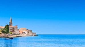A historic building with a prominent tower and a waterfront view. - Apartment in Poreč with Terrace, WIFI (819-3) (Porec)