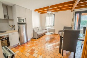 Cozy living space with a kitchenette, sofa, and coffee table.