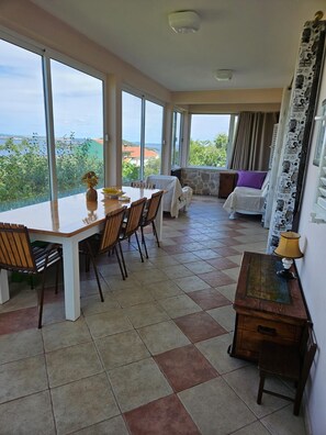 Enjoy meals with family and friends at the large dining table, surrounded by a beautiful view.