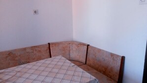 A corner room with a bed, a wall socket, and a light switch. - Apartment in Poljana with Seaview, Terrace, Air condition, WIFI (4232-1) (Poljana)
