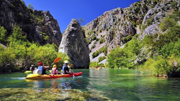 A group kayaking on a clear river surrounded by rocky cliffs and greenery. - Apartment in Karin Gornji with Seaview, Balcony, Air condition, WIFI (4207-1) (Donji Karin)