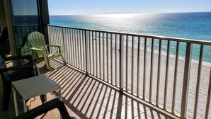 A balcony with a view of the ocean, a table, and two chairs. - Windward bldg at Edgewater, overlook the Sea Oats and Sand! (Panama City Beach)