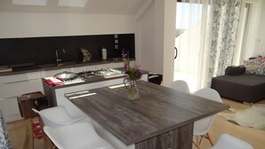 A modern kitchen with a central island, white chairs, and a dining table. - Apartment in Hvar town with Seaview, Loggia, Air condition, WIFI (199-3) (Hvar)