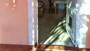 An interior hallway with a tiled floor leading to a room with a bed and a table. - Apartment in Vodice with Terrace, Air condition, WIFI (4441-3) (Vodice)