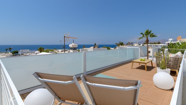 A deck with two lounge chairs, a small table with fruit, and a potted plant. - Casa Capricho, Sun Rooftop Sea Views Lanzarote (Puerto del Carmen)