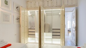 A hotel room with a bed, a wardrobe with sliding doors, and a bathroom visible through the doors. - Casa Capricho, Sun Rooftop Sea Views Lanzarote (Puerto del Carmen)
