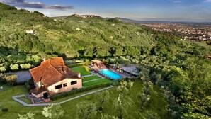 A villa with a swimming pool surrounded by lush greenery and hills. - Villa in Montecatini with 11 bedrooms sleeps 22 (Montecatini)
