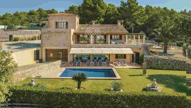 A two-story house with a swimming pool, outdoor seating, and a garden.