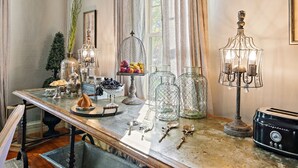 A dining area with a marble table, vintage glassware, and a classic radio. - The Watson Boutique Bed & Breakfast (Thompson)