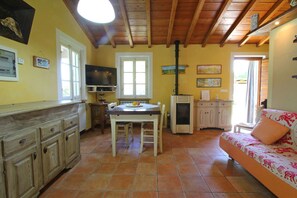 A cozy kitchen with a dining table, wooden cabinets, and a built-in oven. - La Sella - Holiday Home in Tuscany with private pool (Pescaglia)