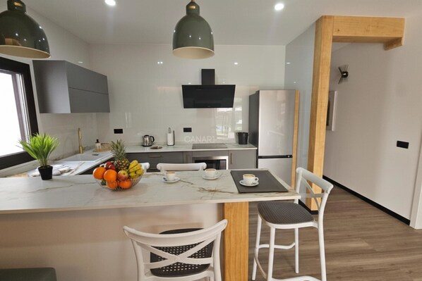 Fridge, microwave, coffee/tea maker, cookware/dishes/utensils