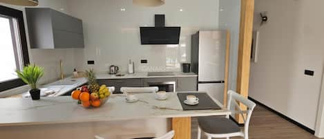 Fridge, microwave, coffee/tea maker, cookware/dishes/utensils