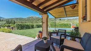 A covered patio with wicker furniture and a view of a pool and greenery. - LA RAFAL  ref. VP26 (Pollensa / Pollen��������������������������������������������������������������a)