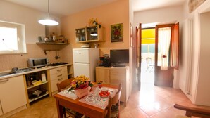 A compact kitchen with a dining area, a refrigerator, a microwave, a coffee maker, and a television. - Vacation Home in Capannori with 1 bedrooms sleeps 2 (Capannori)