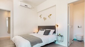 Un dormitorio moderno con cama, mesita de noche y decoración en la pared.