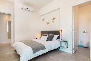 Una camera da letto moderna con un letto, un comodino e decorazioni a parete.