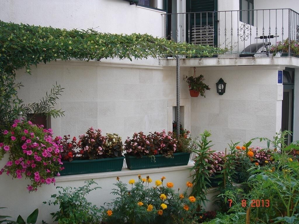 A balcony with potted plants and flowers.