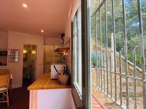 A kitchen with a wooden countertop, a wicker basket, and a sign on the wall.