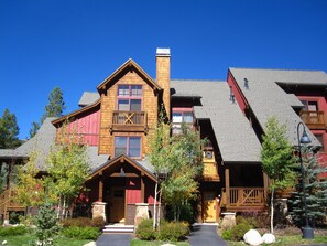 Experience the charm of this traditional lodge, featuring a central chimney and welcoming porch, set amidst serene gardens and mature trees.