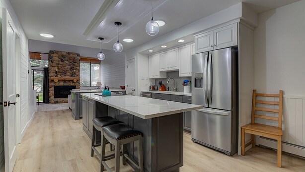 A modern kitchen with a central island, stainless steel appliances, and pendant lighting. - Captain Molly 3 Bedroom Condo, Centrally Located in PC, Mins to Skiing! (Park City)