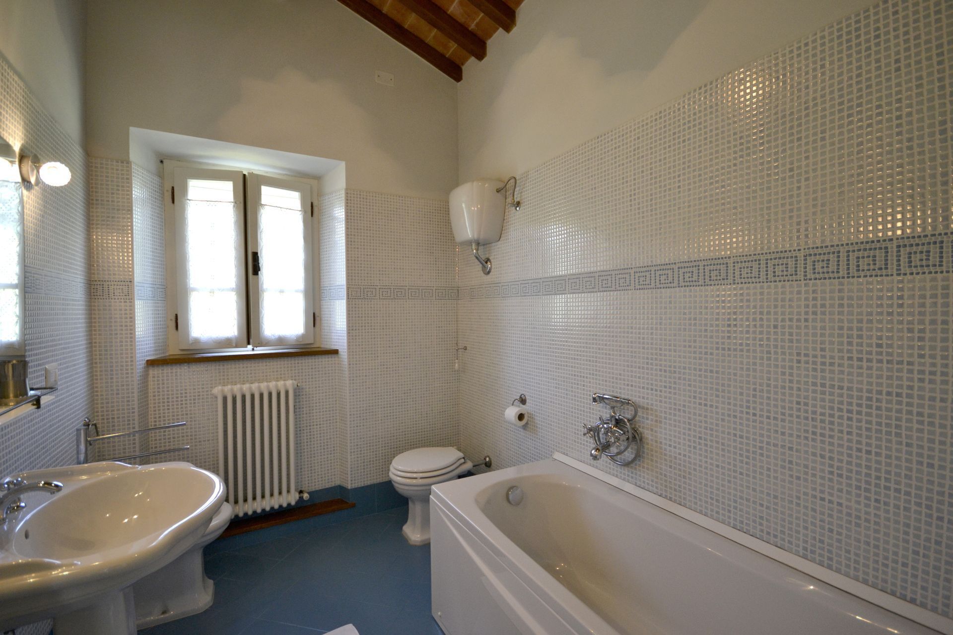 A bathroom with a sink, toilet, and bathtub.