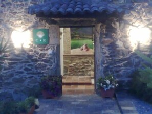 A stone building entrance with a sign reading "C R".