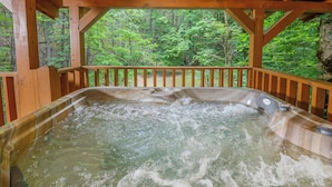 A hot tub with a wooden deck and a forest view. - Very Private w/ Beautiful Scenery of Creeks! Pool, Putt Putt, Fishing, Hiking (Sevierville)