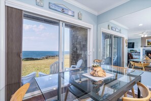 Enjoy ocean views from the dining area with a glass table and chairs.