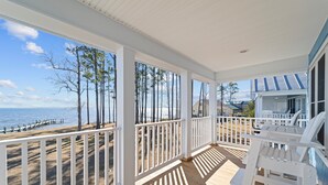 A covered porch with a view of the beach and ocean. - Neuse Village #5 - Quaint, tranquil cottage with pool & amazing views (Arapahoe)