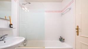 A bathroom with a white sink, a shower, and a bathtub. - Sea View - By WeHostMadeira (Câmara de Lobos)