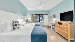 A hotel room with two beds, a TV, a wooden dresser, and a desk with a chair. - 2 Queen Beds. Don`t Leave Your Dog at Home! (Destin)
