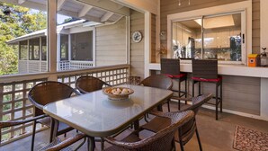 A covered patio with a table and chairs, a ceiling fan, and a view of the house. - 2 BR with a Loft and Beach Service in Private Resort Community (Miramar Beach)